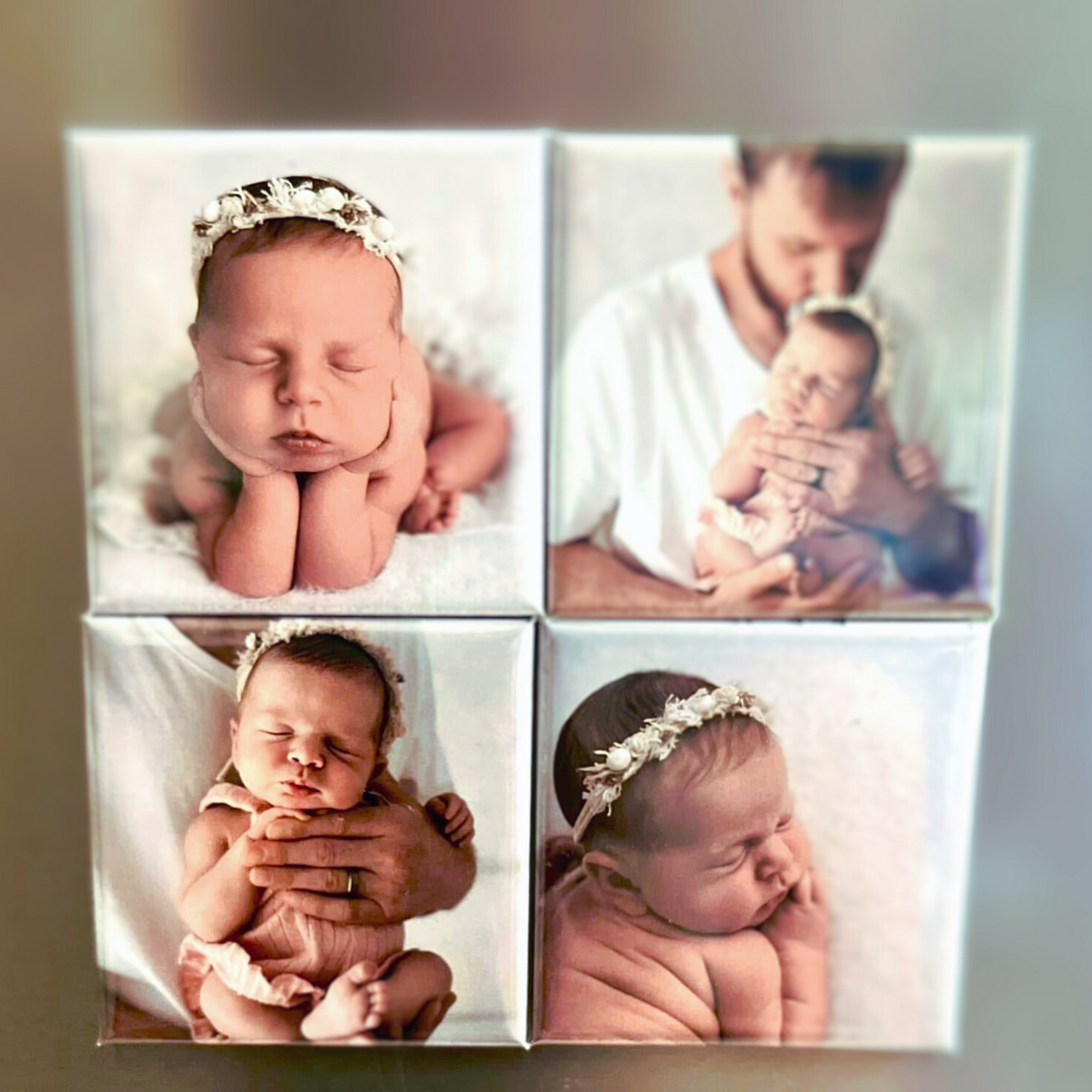 Set of four newborn photo magnets including close-ups of a sleeping baby girl wearing a floral headband, and a tender moment with her father.