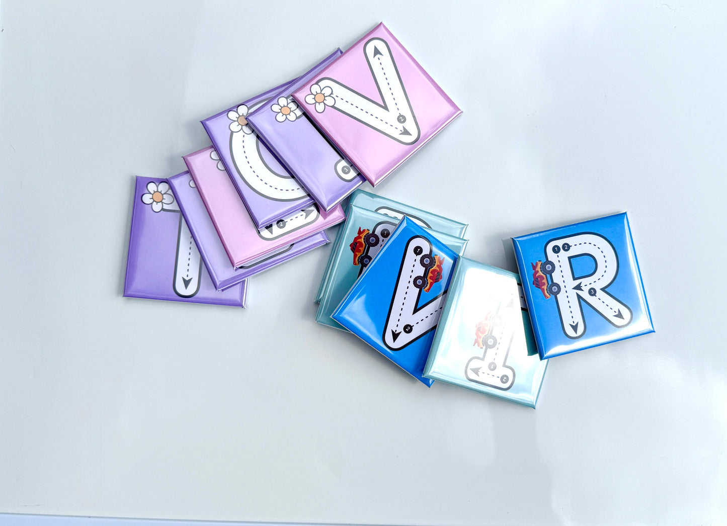Decorative letter 'V' and 'R' magnets on a light gray background