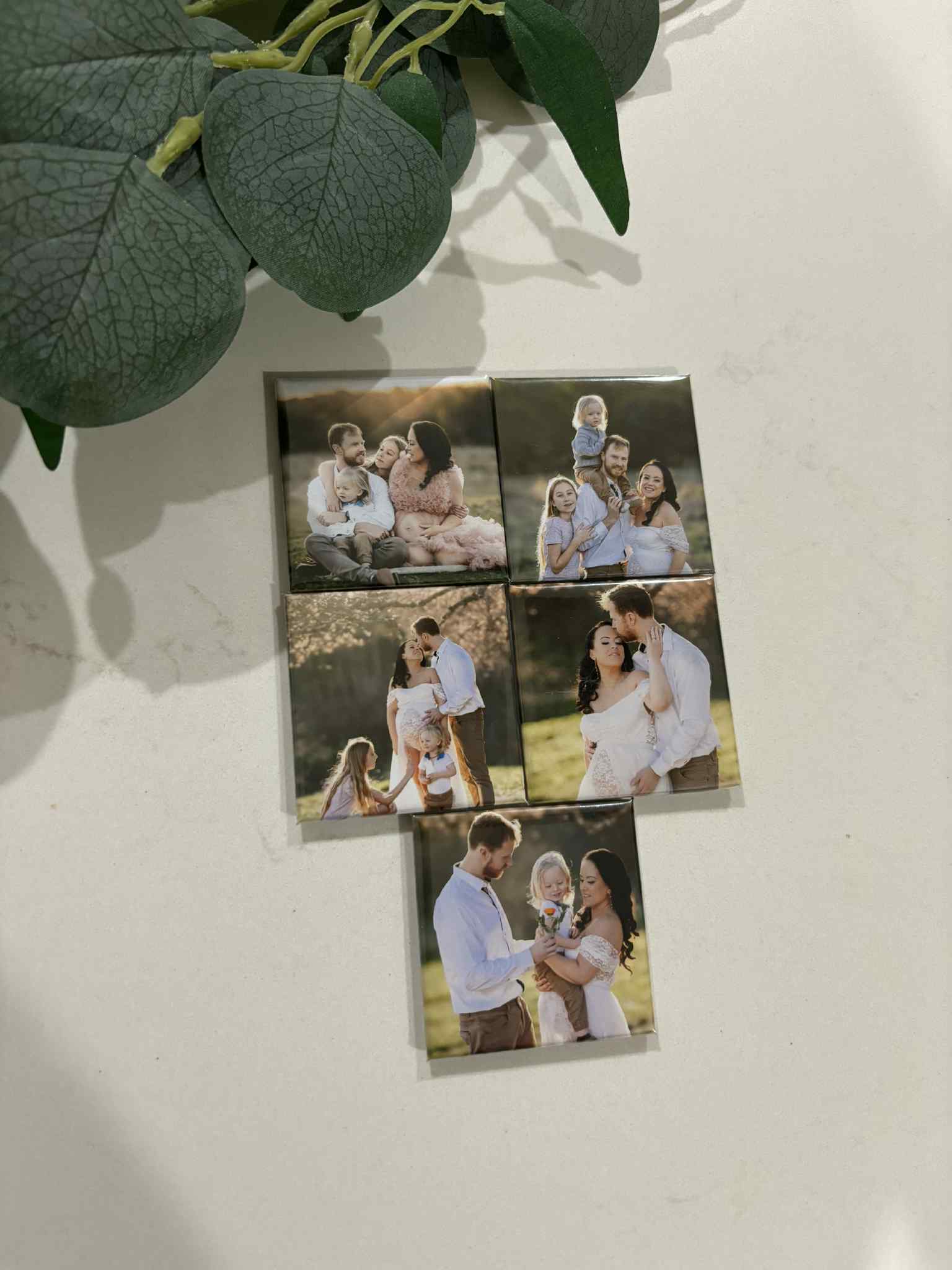  Personalized photo magnet of a couple during a maternity shoot, standing in nature with soft lighting.

