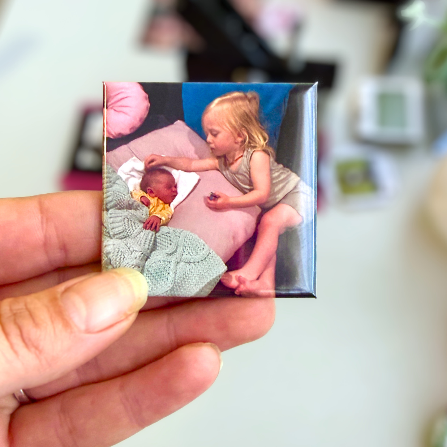 Hand holding a square custom photo magnet featuring a family memory, personalised keepsake gift Australia