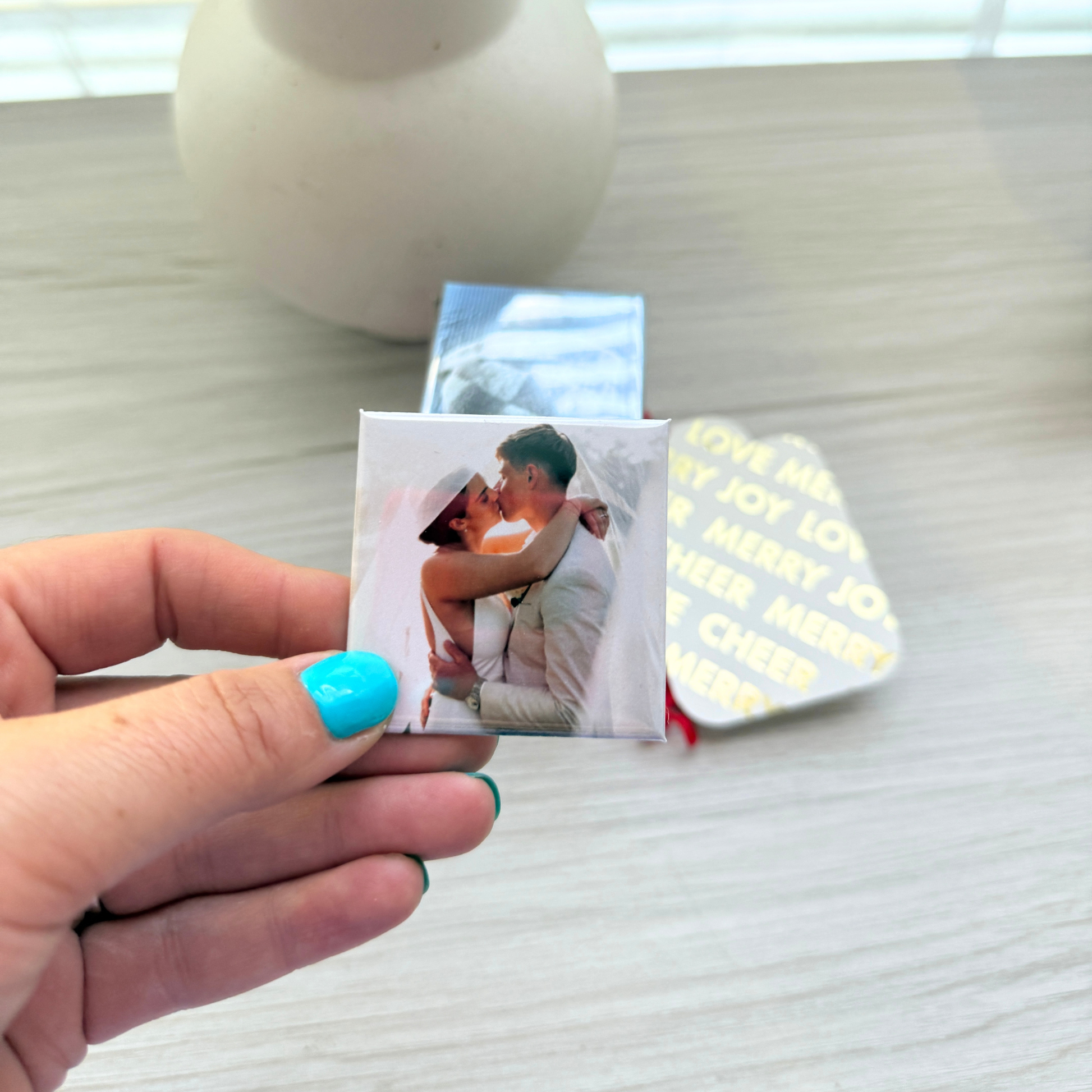 Hand holding a personalised custom photo magnet, unique gift idea Australia