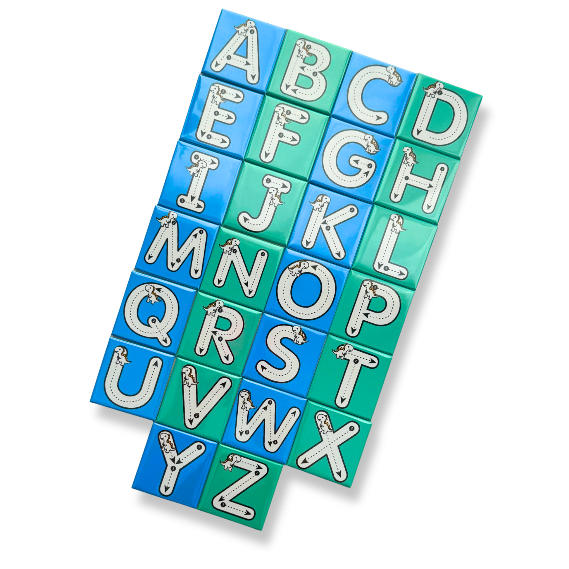 A top-down view of the complete A-Z alphabet tracing magnet set featuring blue and green magnets with dashed tracing lines and small dinosaur illustrations for early learning and handwriting practice.