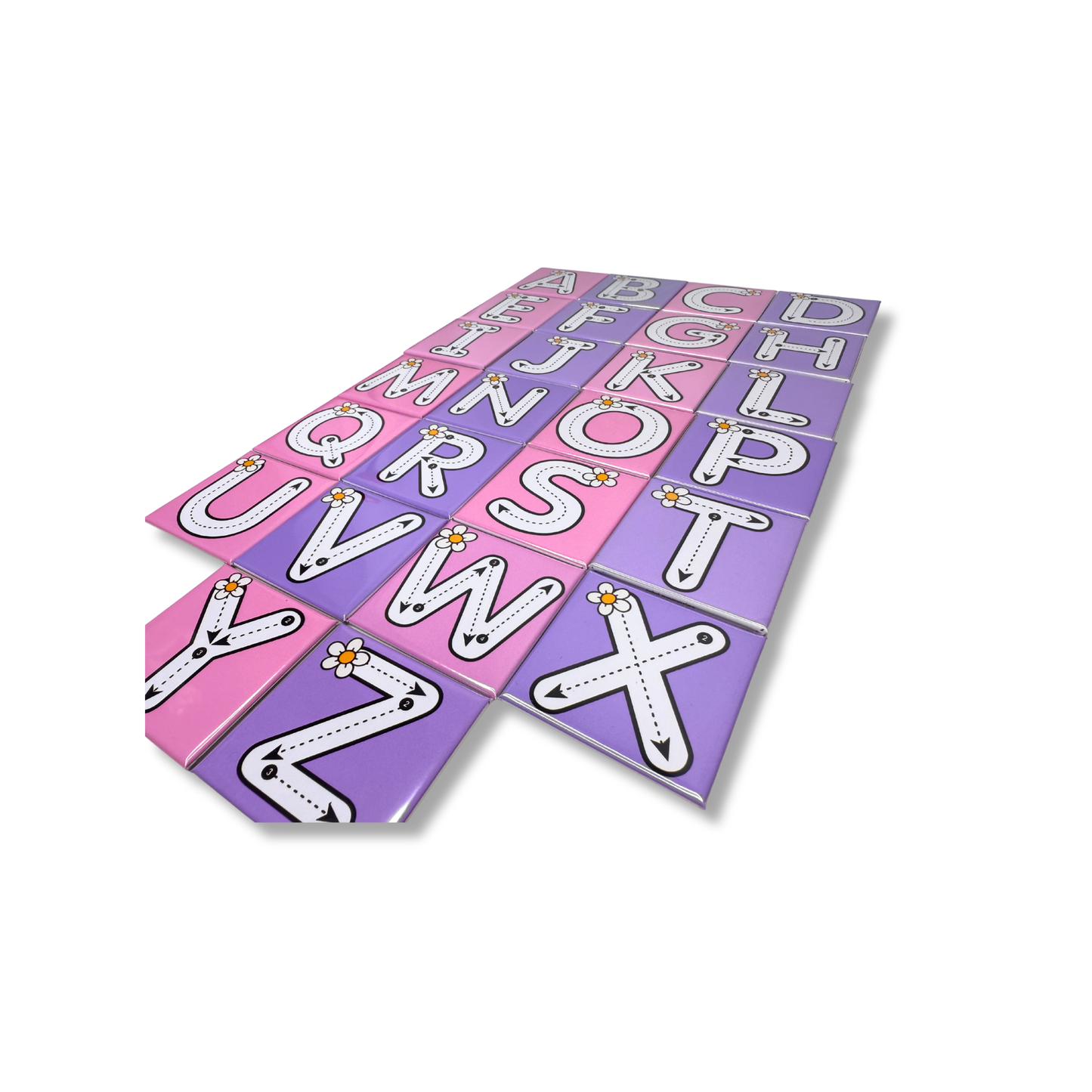 A top-down view of the complete A-Z alphabet tracing magnet set featuring pink and purple magnets with dashed tracing lines and small daisy flower illustrations for early learning and handwriting practice.