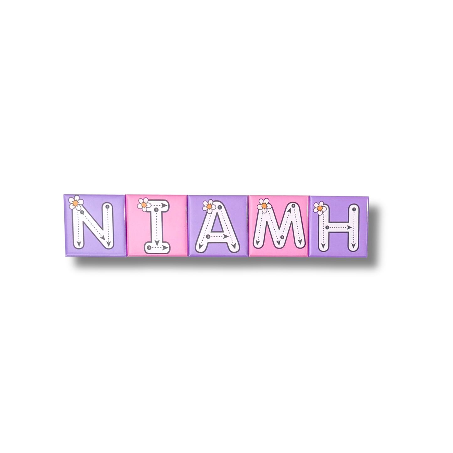Personalised name tracing magnets spelling out the name "Niamh". The magnets are pink featuring dashed tracing lines and a flower illustration for early learning and name recognition. 