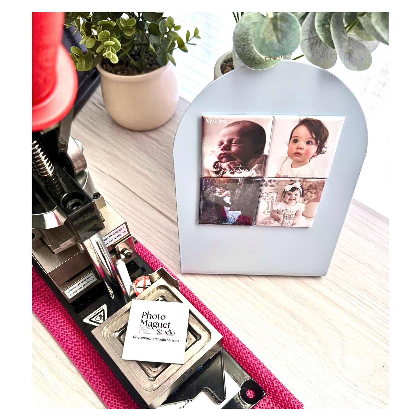 Photo Magnet Studio maker machine on wooden table with custom baby photo magnets on display