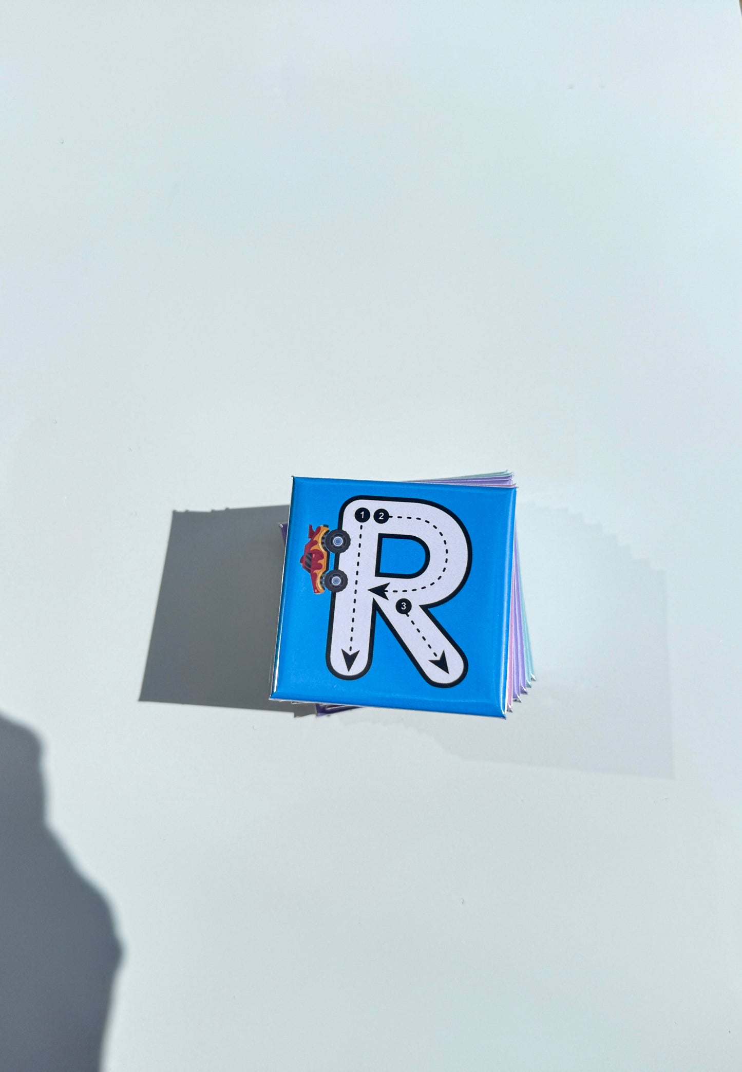 Small blue magnet with a letter 'R' on a light gray background